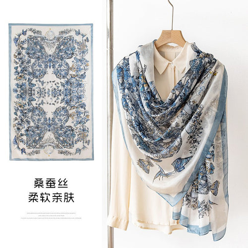 Blue floral and bird mulberry silk art scarf styled on a white shirt